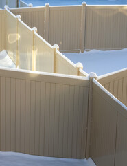 Fence geometry. Plastic fence for the backyards under fresh snow