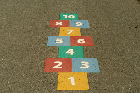 Hopscotch game in primary colours on pavement; Washington, Tyne and Wear, England