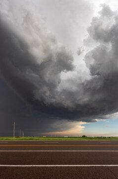 Supercell thunderstorm looms overhead somewhere over the West Kansas prairie; Kansas, United States of America