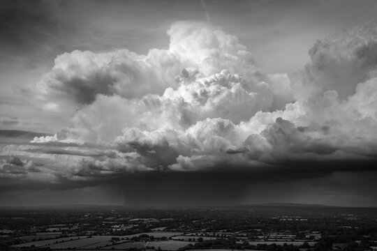 A line of towering cumulus clouds drifts across the English countryside; Brighton, East Sussex, England