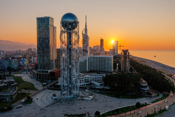 Fototapeta premium Alphabet tower at the sunset, Batumi City, Georgia, drone aerial view