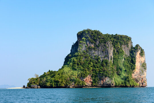 View of small beach on a tropical island in the waters of the Strait of Malacca; Phang Nga Bay, Thailand