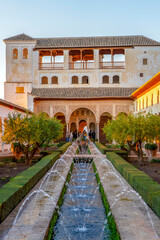 Fototapeta premium Fountain in green gardens of ancient Alhambra in Granada, Spain on November 26, 2022 