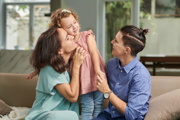 Joyful family of three spending weekend at home