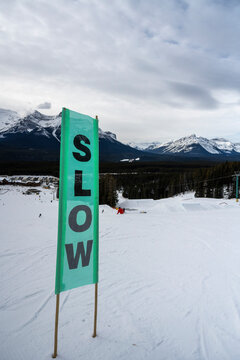 Sign to require slowing down towards the end of a ski run at a ski resort in Banff National Park, Alberta, Canada; Improvement District No. 9, Alberta, Canada