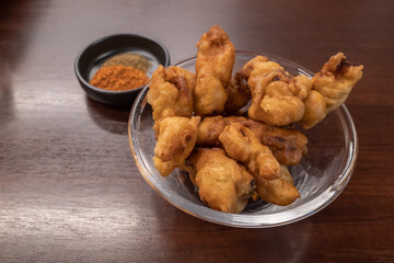 Chinese style of crispy fried belly pork with spicy chilli powder on side. 