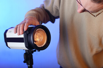 studio lamp without modifier with a bare burner with a person - obrazy, fototapety, plakaty