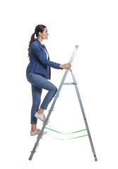 Young woman climbing up metal ladder on white background