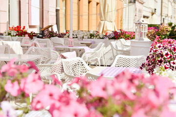 Outdoor cafe with beautiful flowers and comfortable furniture
