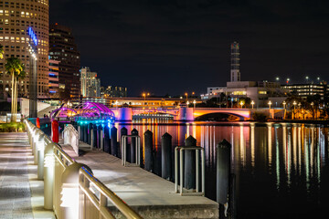 Fototapeta na wymiar riverwalk with lighted bridge