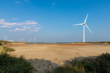 Cement concrete dam and white wind turbine, The Delta Works is a projects to protect a large area...