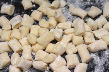 raw gnocchi made at home. preparing italian meal. raw gnocchi with flour to be cooked.