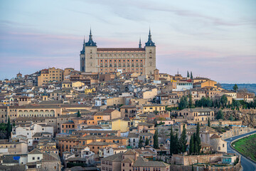 Views of the city of Toledo and its Alcazar, civil and military fortification, during sunrise on a clear and sunny day - obrazy, fototapety, plakaty