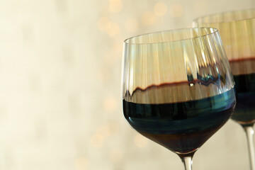 Glasses of red wine on light background, closeup. Space for text