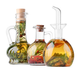 Different sorts of cooking oil with spices and herbs in bottles on white background