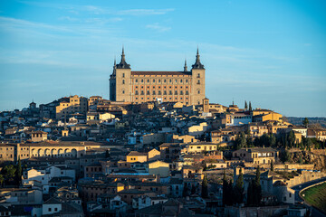 Fototapeta na wymiar Views of the city of Toledo and its Alcazar, civil and military fortification, during sunrise on a clear and sunny day