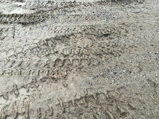asphalt road with dirt tracks on the ground