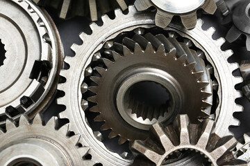Many different stainless steel gears as background, top view