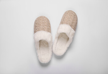 Pair of beautiful soft slippers on white background, top view