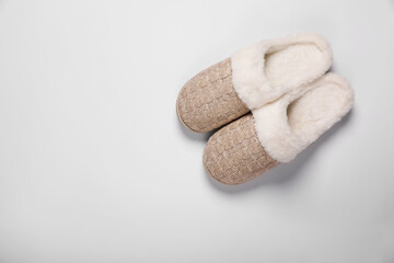 Pair of beautiful soft slippers on white background, top view. Space for text