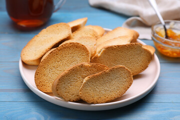 Plate of hard chuck crackers on light blue wooden table