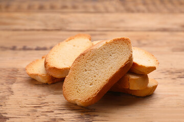 Tasty hard chuck crackers on wooden table, closeup