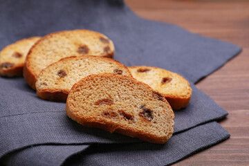Sweet hard chuck crackers with raisins on wooden table, closeup