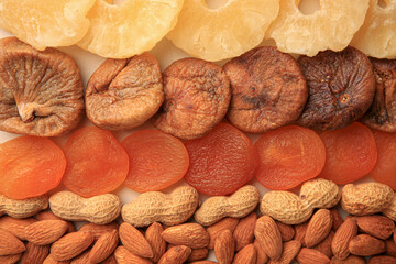 Different tasty nuts and dried fruits as background, top view