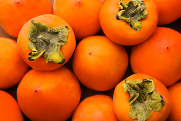 Delicious ripe juicy persimmons as background, top view
