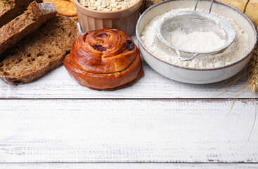 Different gluten free products on white wooden table, space for text
