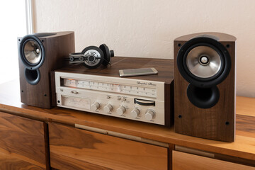 Home Stereo Receiver with Speakers and Headphones Placed on Wooden Retro Shelf - 556843343