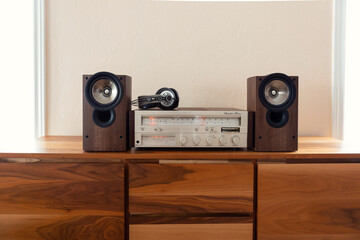 Home Stereo Receiver with Speakers and Headphones Placed on Wooden Retro Shelf - 556843384