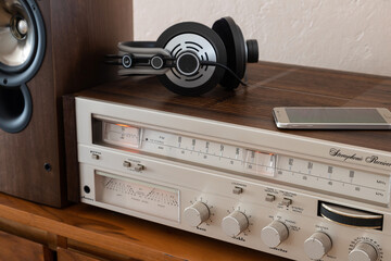 Home Stereo Receiver with Speakers and Headphones Placed on Wooden Retro Shelf - 556843386