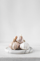 Garlic bulbs on a marble tray, garlic, raw garlic, Allium sativum
