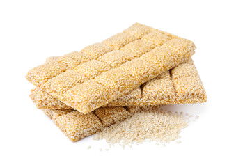 Delicious sweet kozinaki bars and sesame seeds on white background