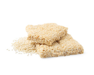 Delicious sweet kozinaki bars and sesame seeds on white background