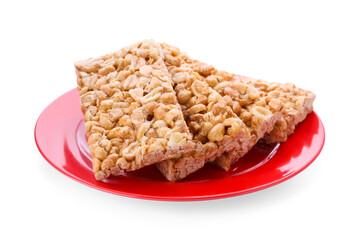 Plate with tasty peanut bars (kozinaki) isolated on white