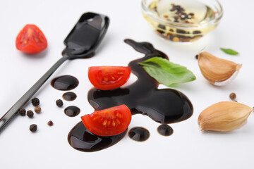 Organic balsamic vinegar and cooking ingredients on white background