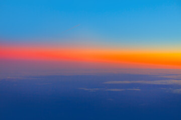 Sky with colorful dusk . Vibrant sky view during flight