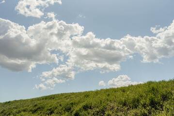 hillside with blue sky and clouds
