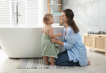 Mother with her daughter after bath at home