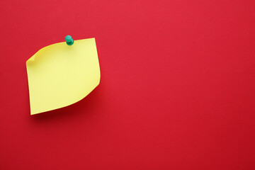 Paper note on red background, top view. Space for text