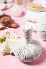 Obraz na płótnie Canvas Herbal massage bags and other spa products on pink background, closeup