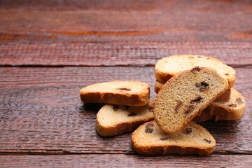 Sweet hard chuck crackers with raisins on wooden table. Space for text