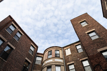 View looking up at old brick apartment buildings, generic urban housing seen from the rear, horizontal aspect