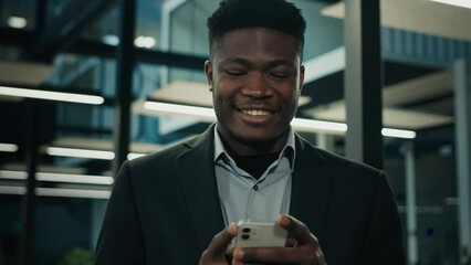 African businessman young male entrepreneur user executive worker employee ethnic man texting message on phone smiling read good mobile notification chatting online business chat cell communication - Powered by Adobe