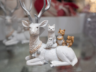 Reindeer Christmas decorative figurine on blurred background. Hand made Christmas toys decor.