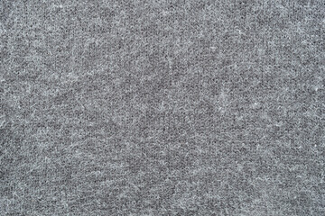Texture of gray woolen knitted fabric. Grey wool knit cloth background. Knitted pattern