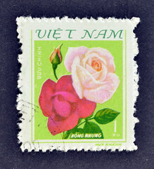 Cancelled postage stamp printed by Vietnam, that shows Red and pink roses, circa 1980.