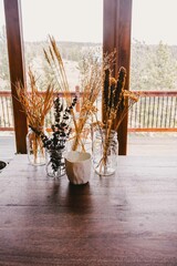 Dried flower arrangements on a wooden table in a mountain cabin in Colorado